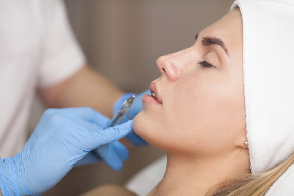 Customer receiving dermal filler treatment in a beauty salon